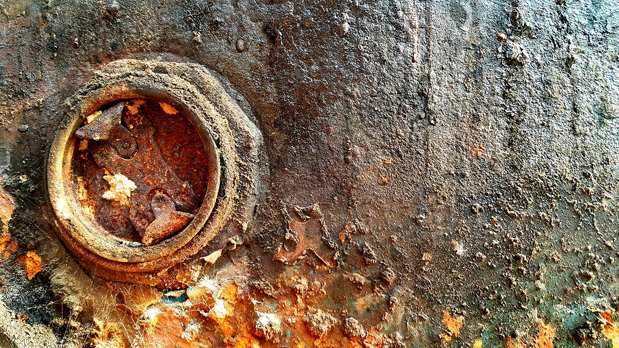 Close up of old rusted and dirty metal oil storage barrel