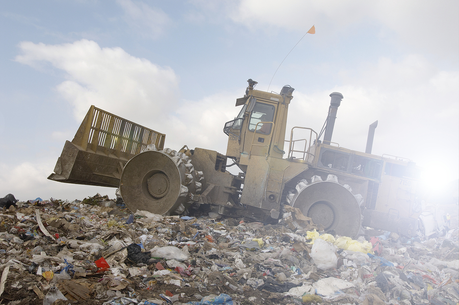 Bulldozer and rubbish garbage tip dump landfill
