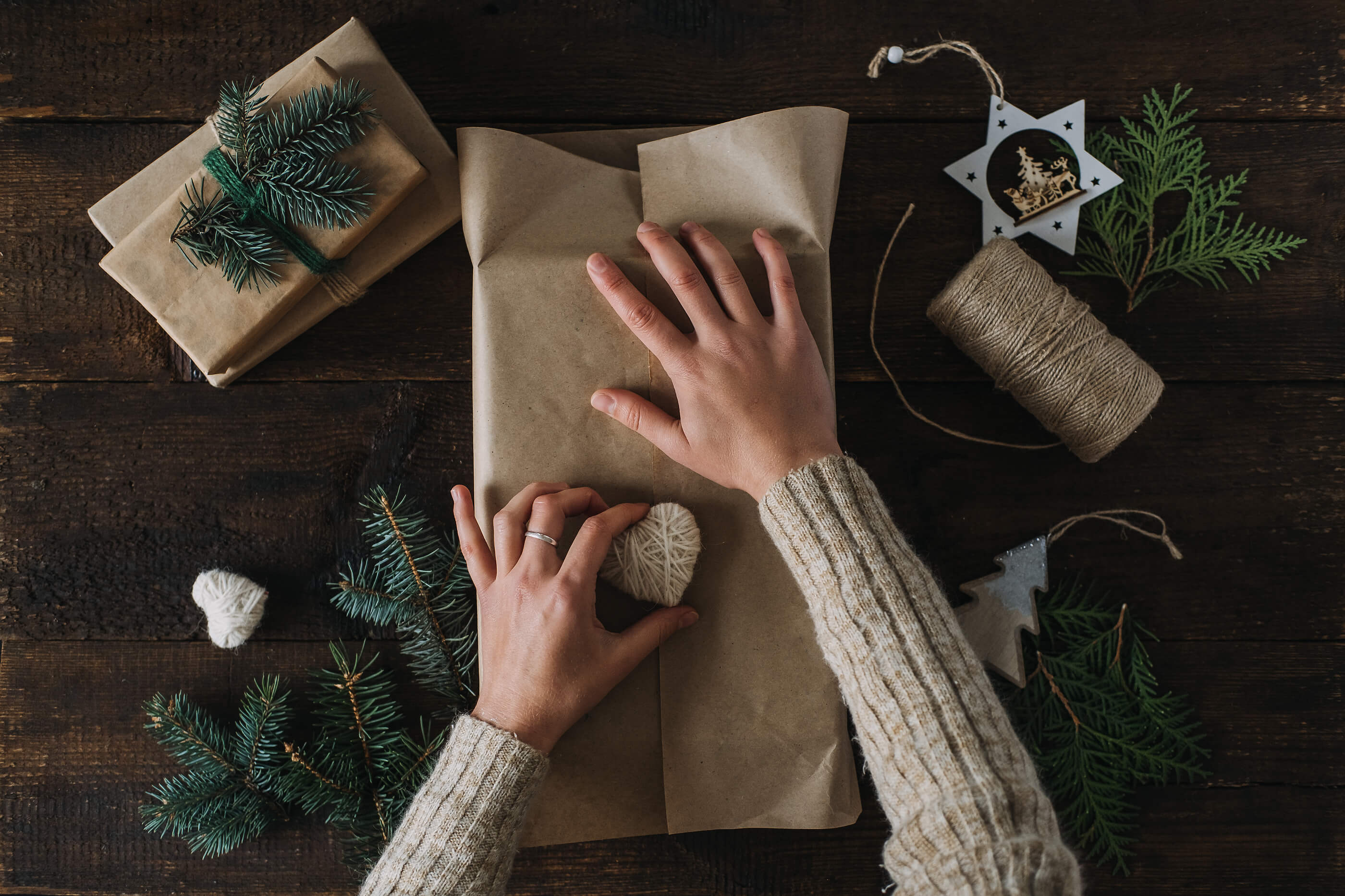 a person wrapping a present with paper.