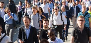 London, UK - April 19, 2018: Blurred image of office workers crossing the London bridge in early morning on the way to the City of London, the leading business and financial area in Europe. Rush hours