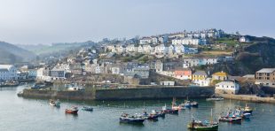 Mevagissey Cornwall - April 12 2018: Mevagissey harbour within the Cornwall Area of Outstanding Natural Beauty the village dates to the medieval period and is a popular destination for tourists