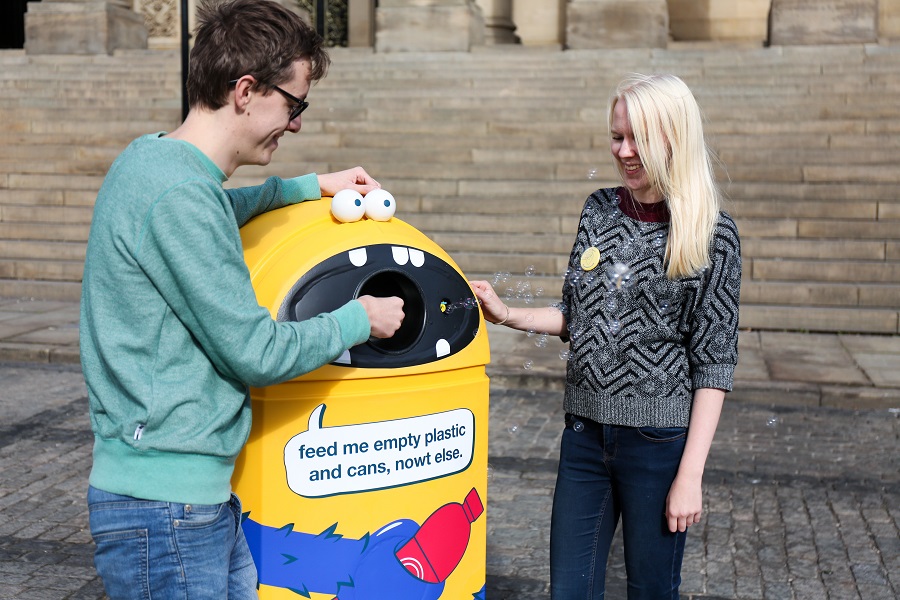 People using the recycling bins