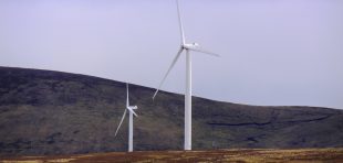 Wind turbines in remote part of Sutherland, Scotland, Europe. A wind turbine is a rotating machine which converts the kinetic energy in wind into mechanical energy. The mechanical energy is then converted to electricity