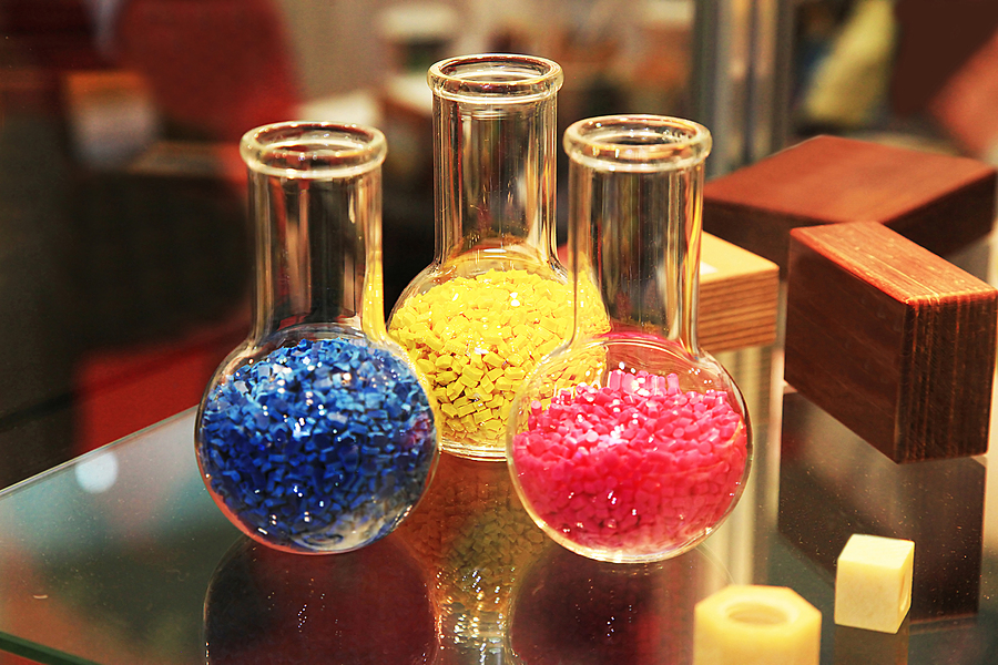 Colored polymer granules in glass flasks in laboratory