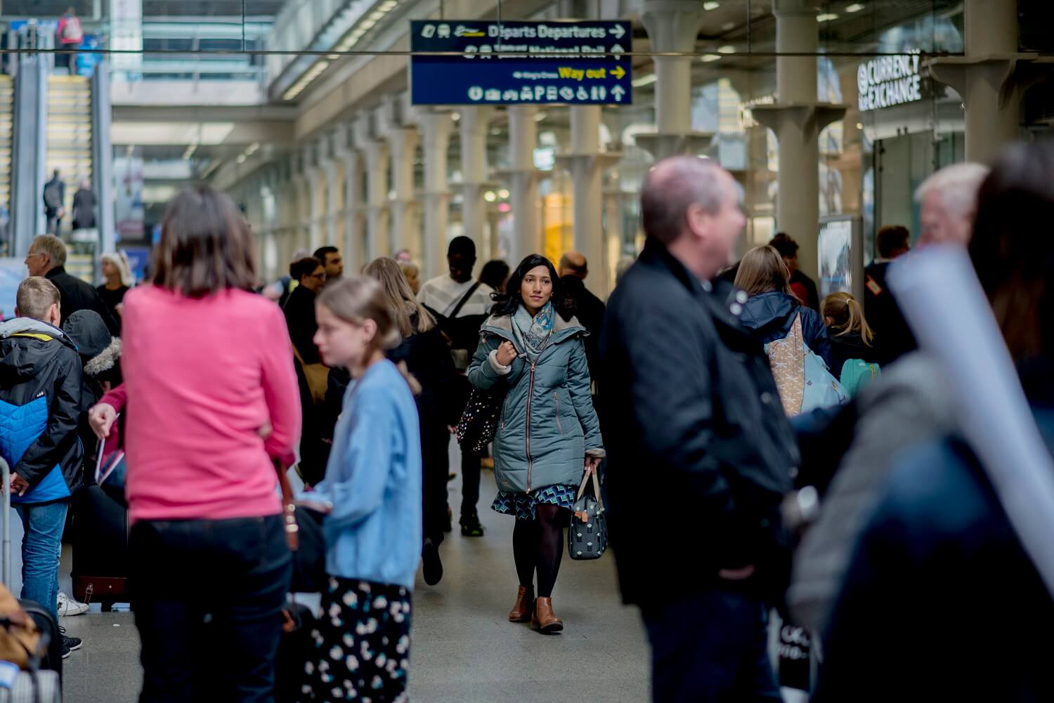 A picture of commuters in a busy city station.