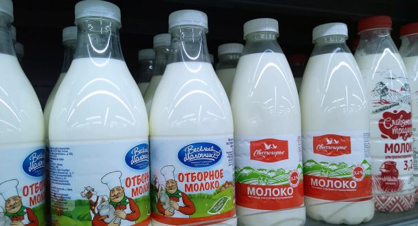 Nilk bottles sit on a shelf, ready to be sold to milk.