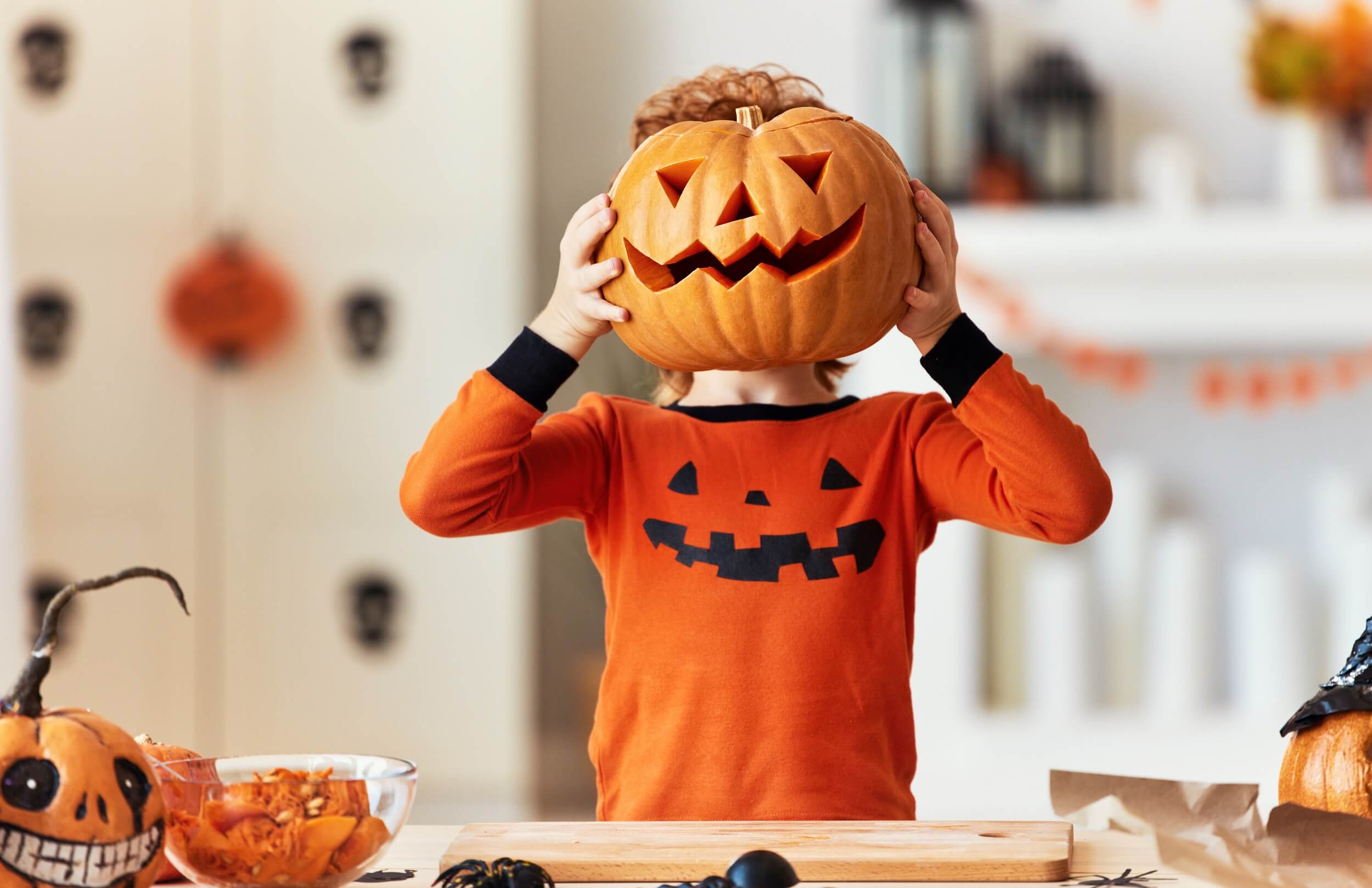 A child becomes a pumpkin monster at halloween