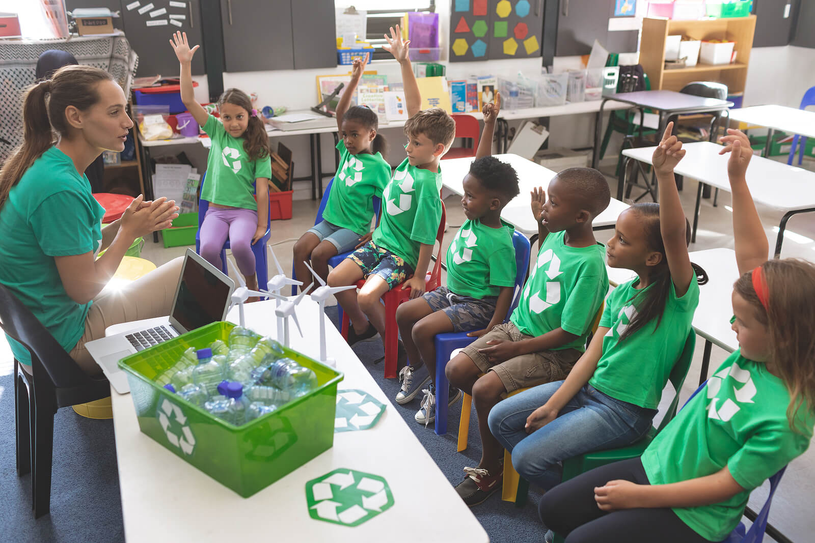 school-children-classroom-hands-up-recycling