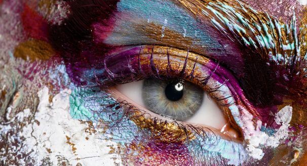 A girl with multiple layers of beautiful makeup across her eye