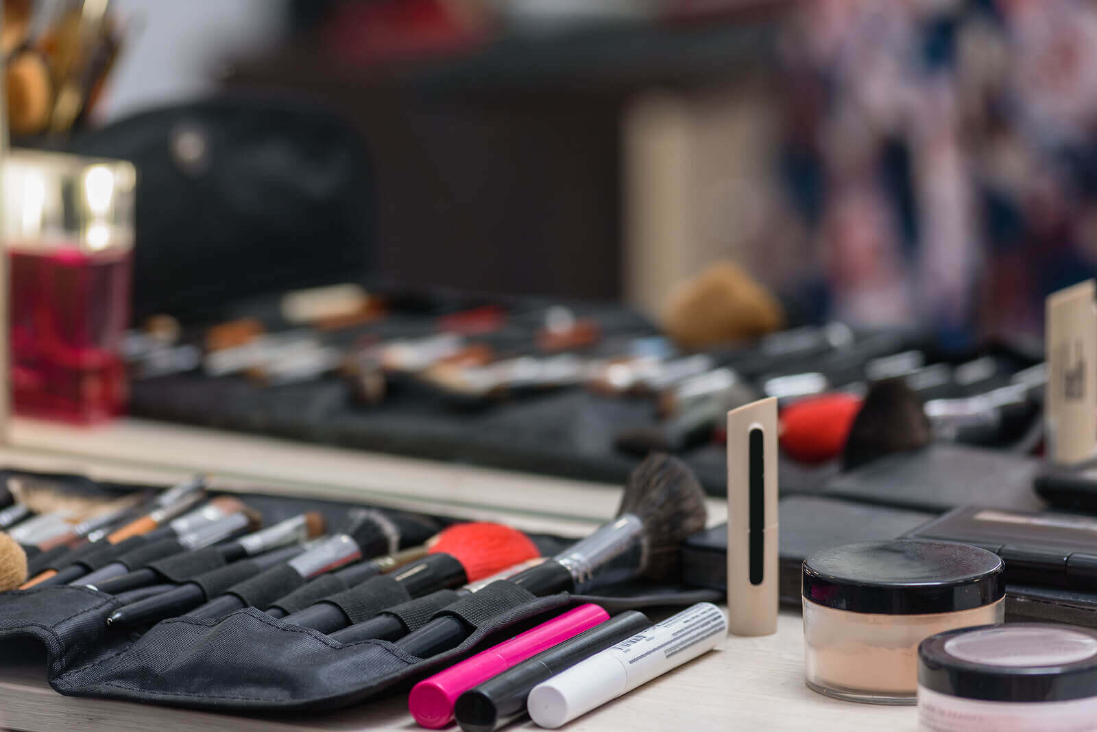 A full and colourful makeup set sits on a table.